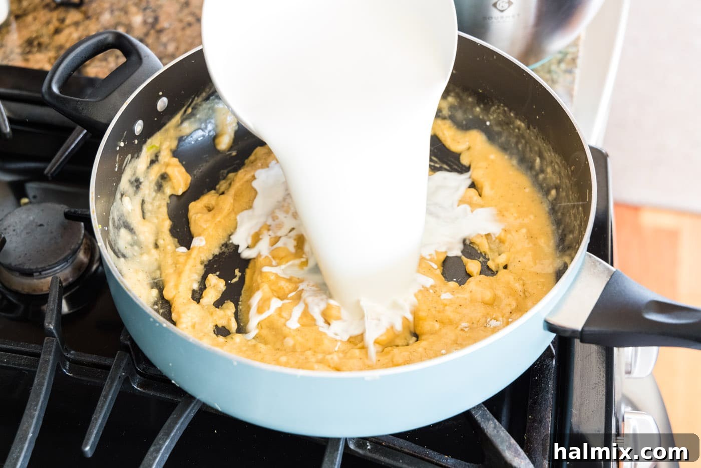 Fisherman's Lasagna 13 Pouring half and half into the skillet with the roux, beginning to form the creamy sauce.