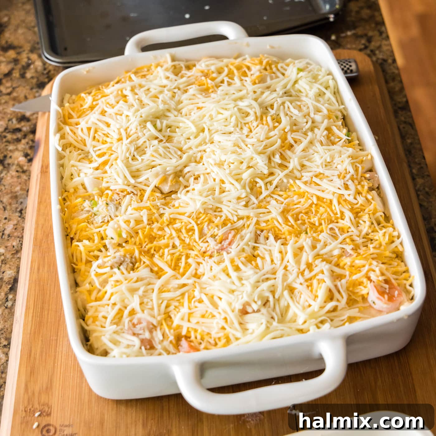 Fisherman's Lasagna 22 The final top layer of shredded cheese generously covering the seafood lasagna before baking.