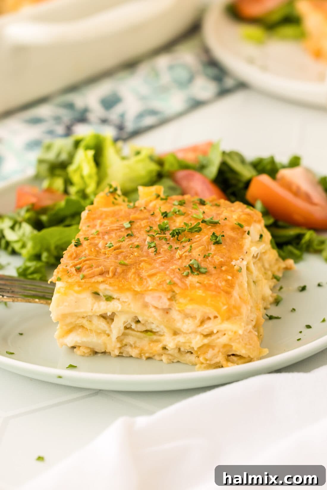 Fisherman's Lasagna 24 A perfectly baked slice of Seafood Lasagna on a plate, showing the distinct layers of noodles, seafood, creamy sauce, and melted cheese, ready to be enjoyed.