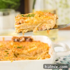 A slice of Seafood Lasagna on a spatula, showcasing its layers and creamy texture.