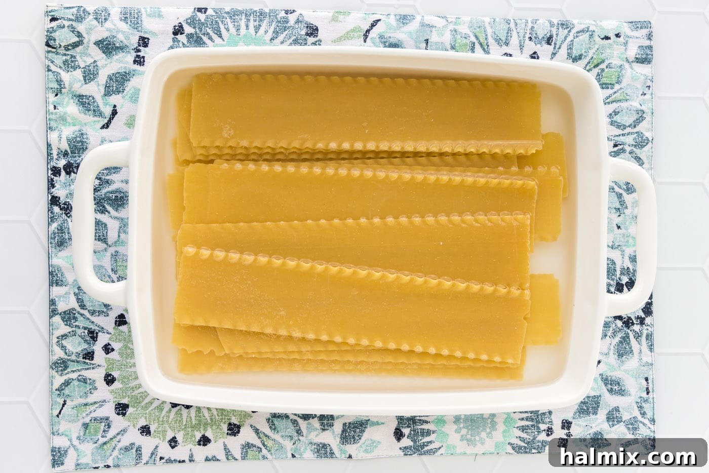 Fisherman's Lasagna 5 Lasagna noodles soaking in hot water in a 13x9 baking dish, becoming pliable.