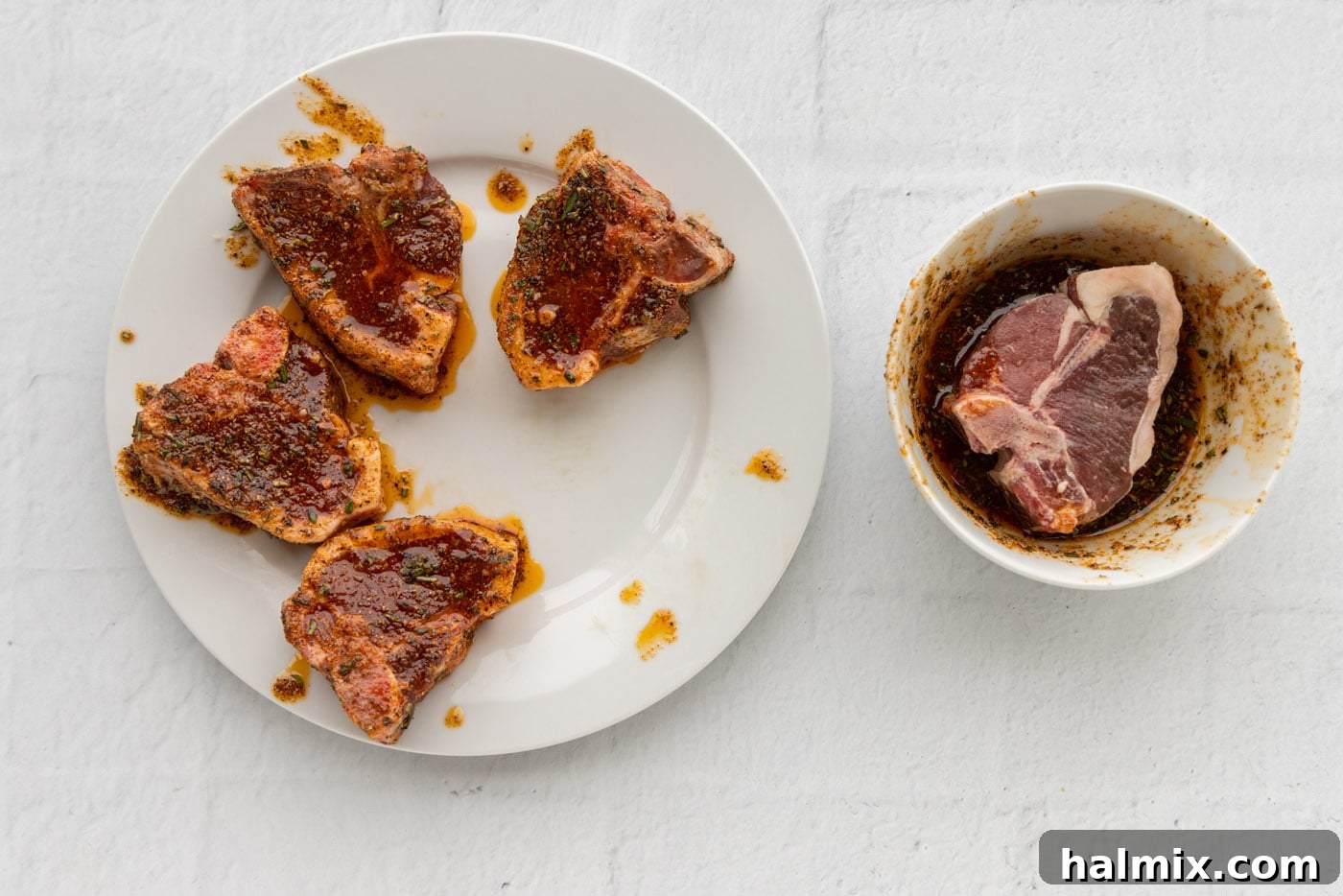 Lamb chops carefully coated with the wet rub marinade mixture on a plate