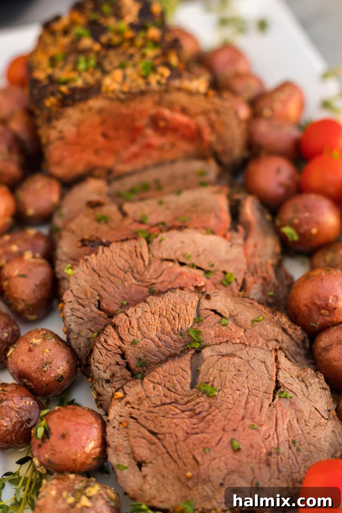 Sliced Beef Tenderloin on a platter, showcasing its perfectly cooked interior and crispy crust