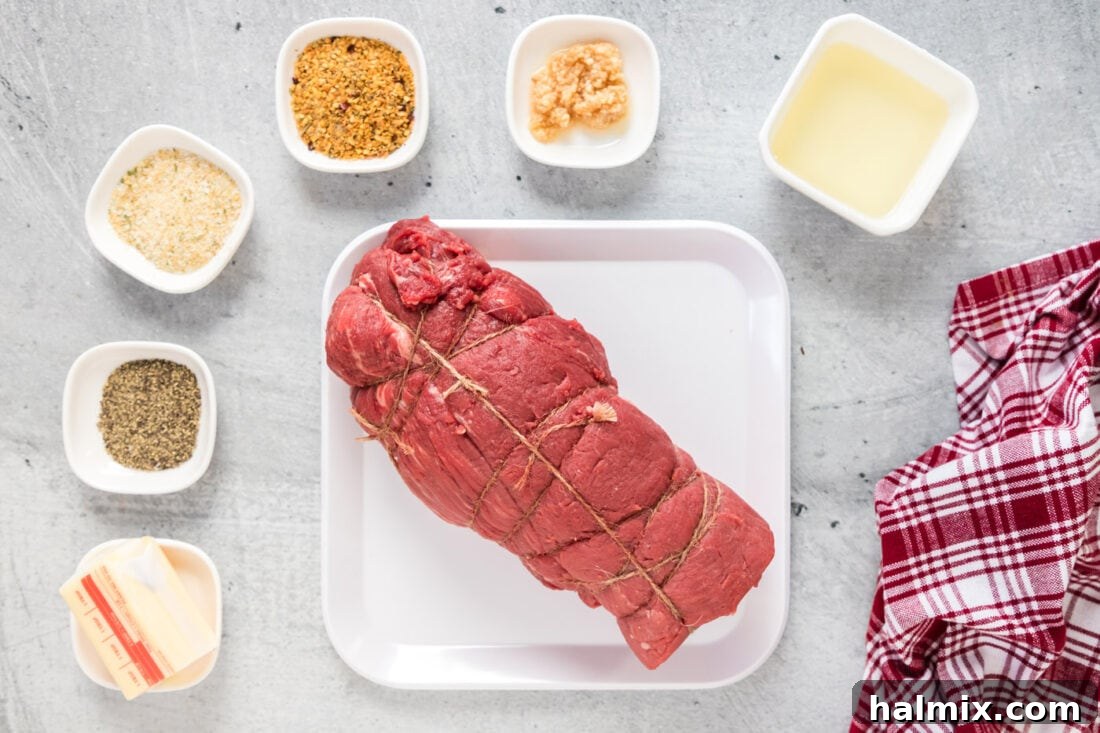 Ingredients laid out for preparing Beef Tenderloin, including a whole tenderloin, spices, and butter