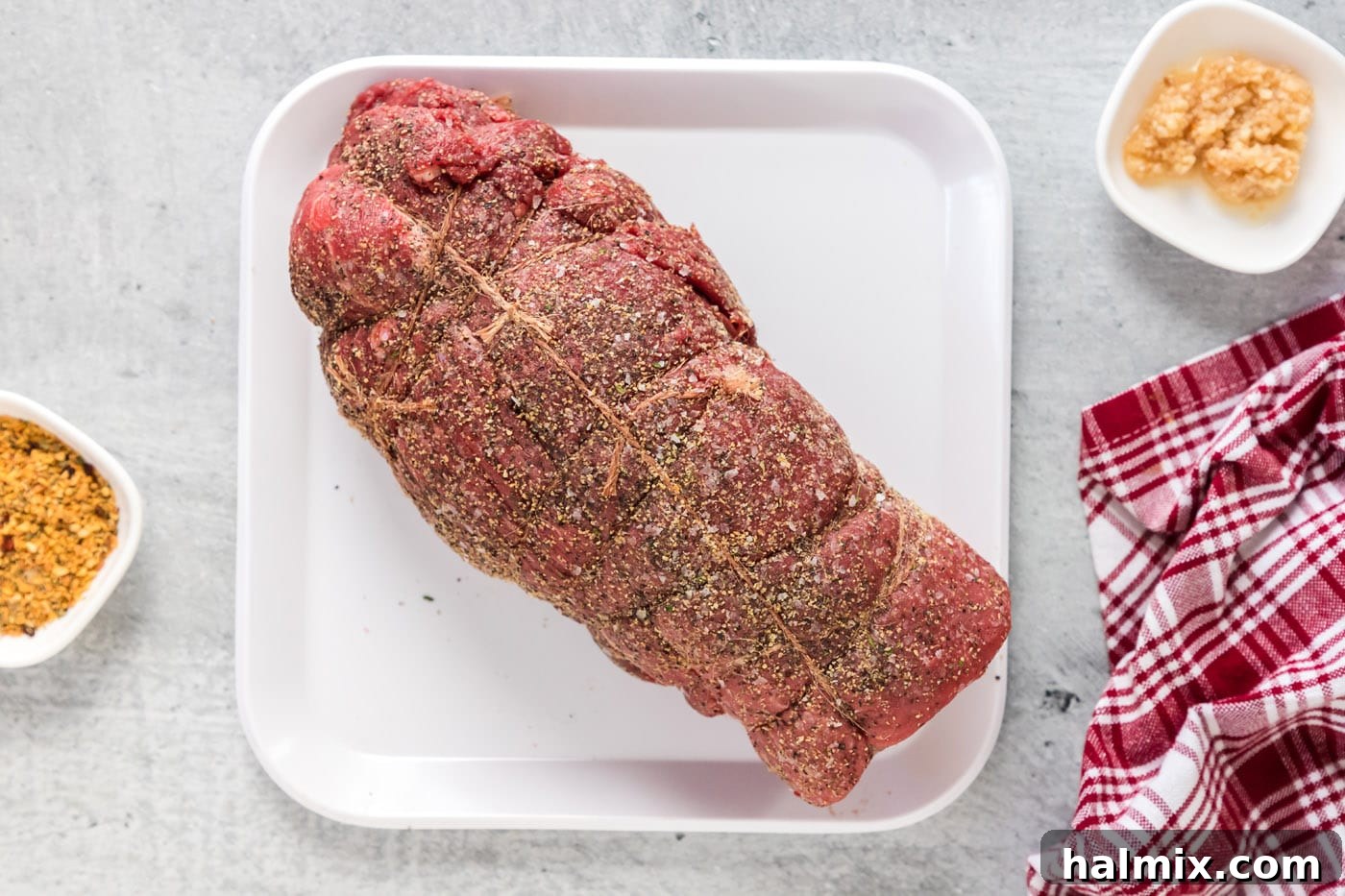 seasoned beef tenderloin wrapped in butchers twine, ready for searing
