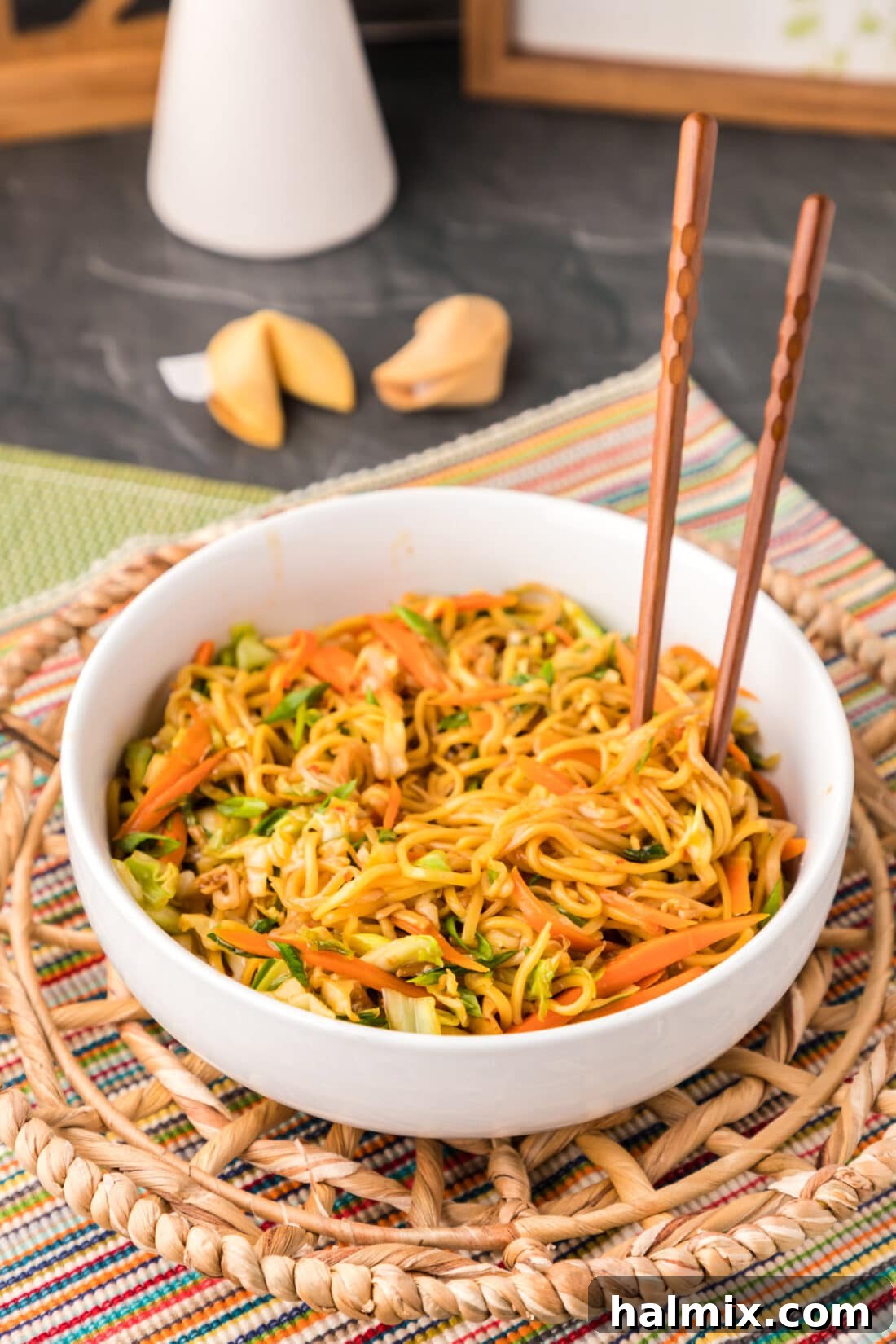Chopsticks poised over a bowl of freshly prepared Chow Mein, ready to be enjoyed.