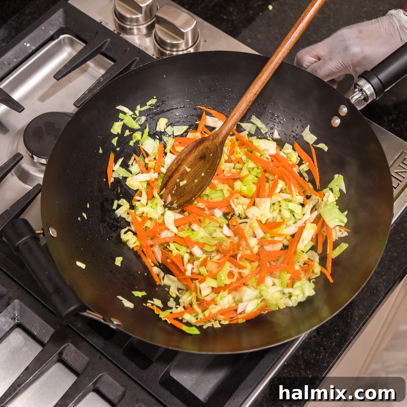 Mixing chow mein vegetables in a wok