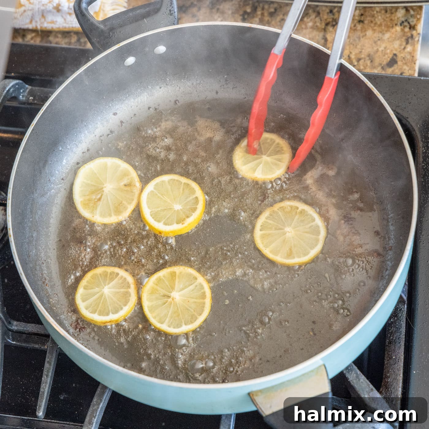 Sautéing Lemon Slices Lemon slices sautéing in the flavorful chicken drippings in the skillet