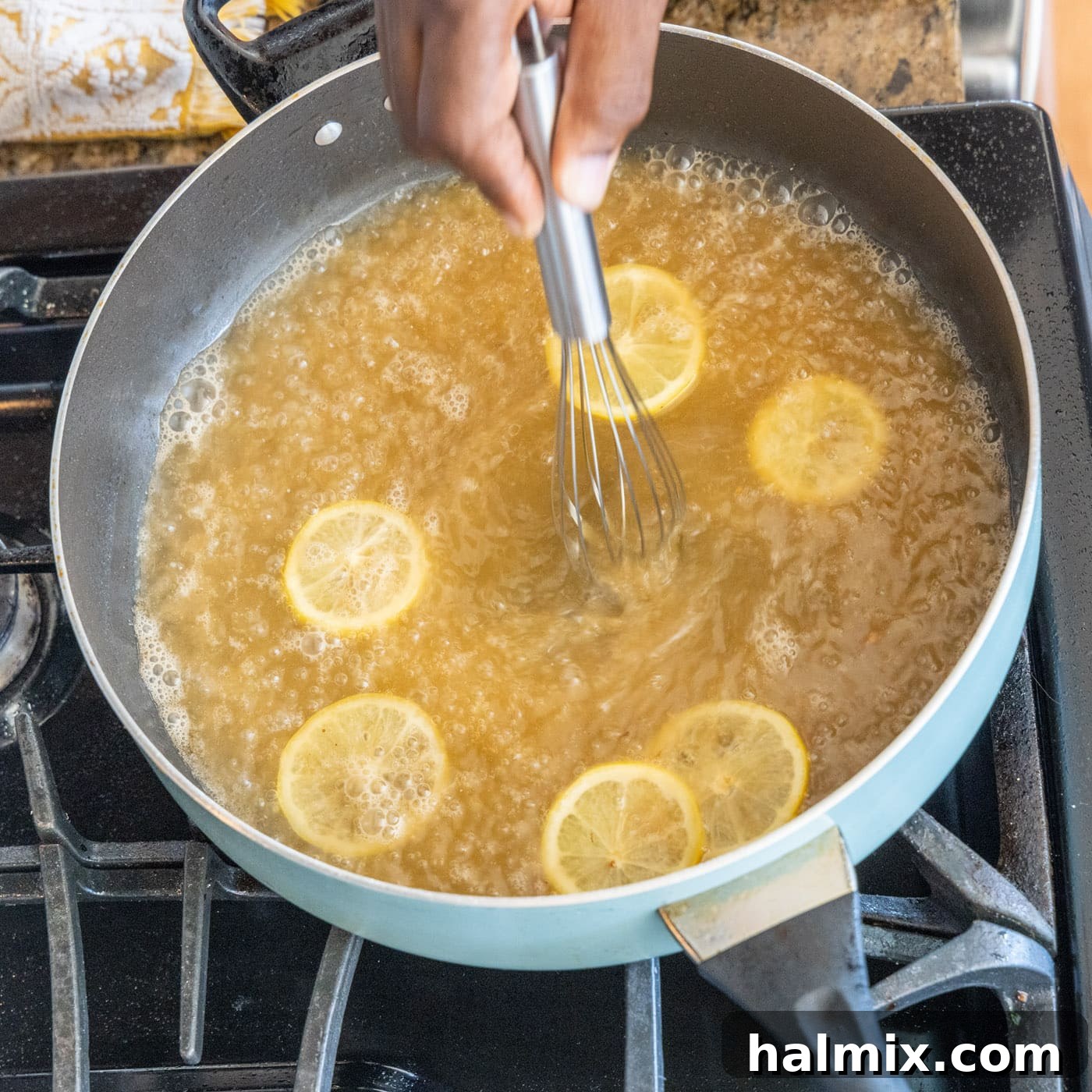 Whisking Sauce Ingredients Whisking lemon juice, white wine, and chicken stock in the skillet for the Francese sauce