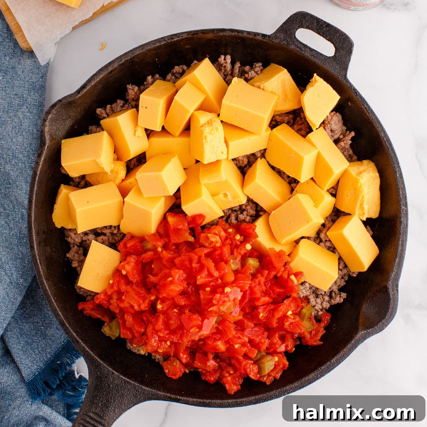 Rotel tomatoes, Velveeta cheese, and ground beef dip in a skillet