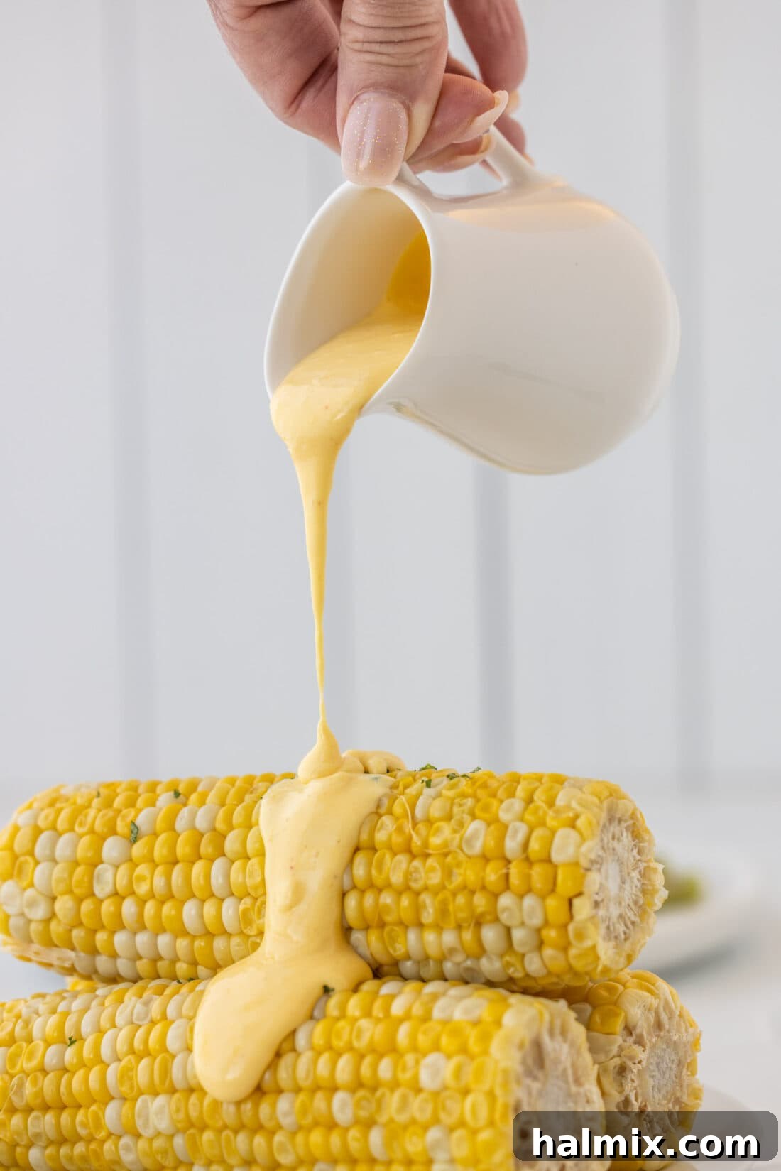 Velvety Hollandaise Sauce 8 pouring Hollandaise Sauce on corn