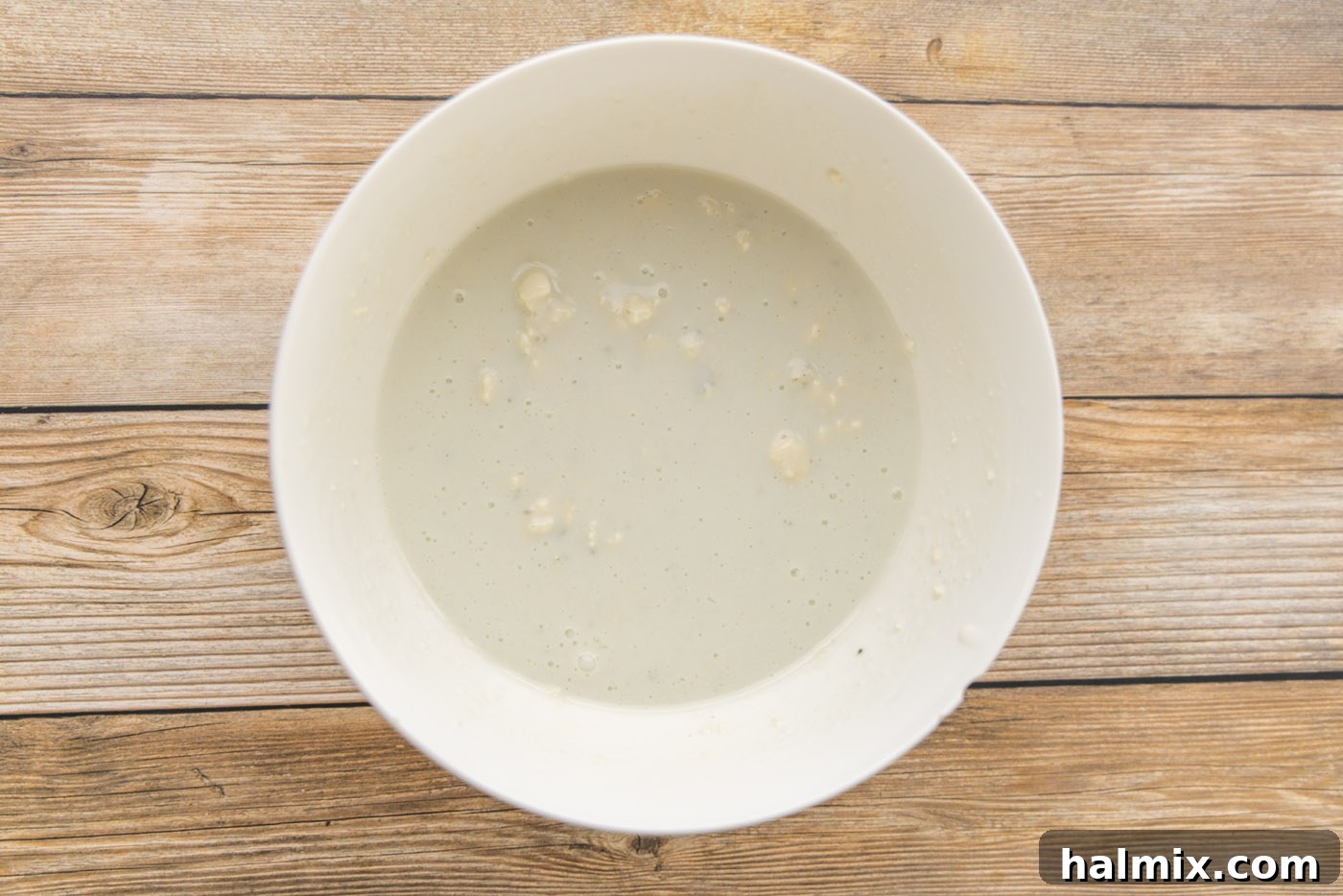 buttermilk and blue cheese crumbles in a mixing bowl