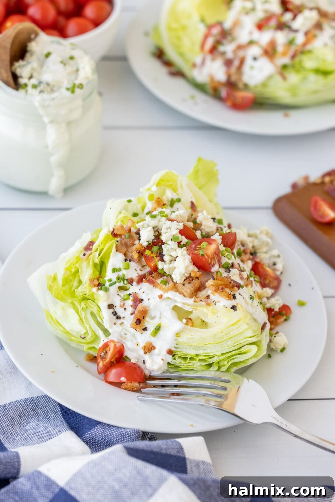 A beautifully plated Wedge Salad, showcasing its crisp lettuce, bacon, blue cheese, and tomatoes.
