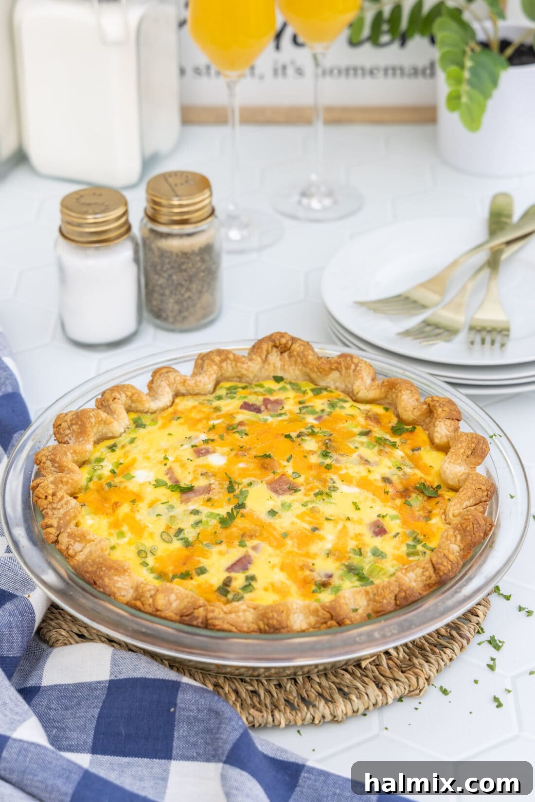 Close-up of the baked quiche in its pan, showing the rich texture and golden top.