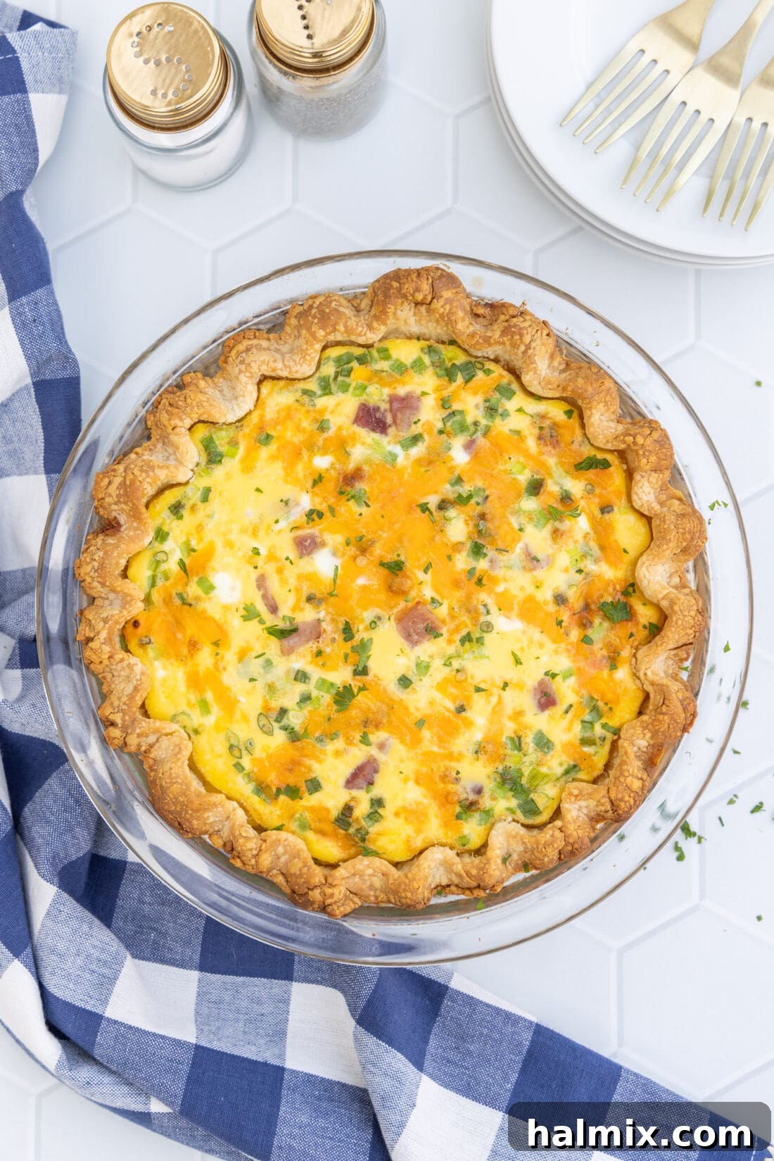 Whole quiche with a golden-brown crust, fresh out of the oven.