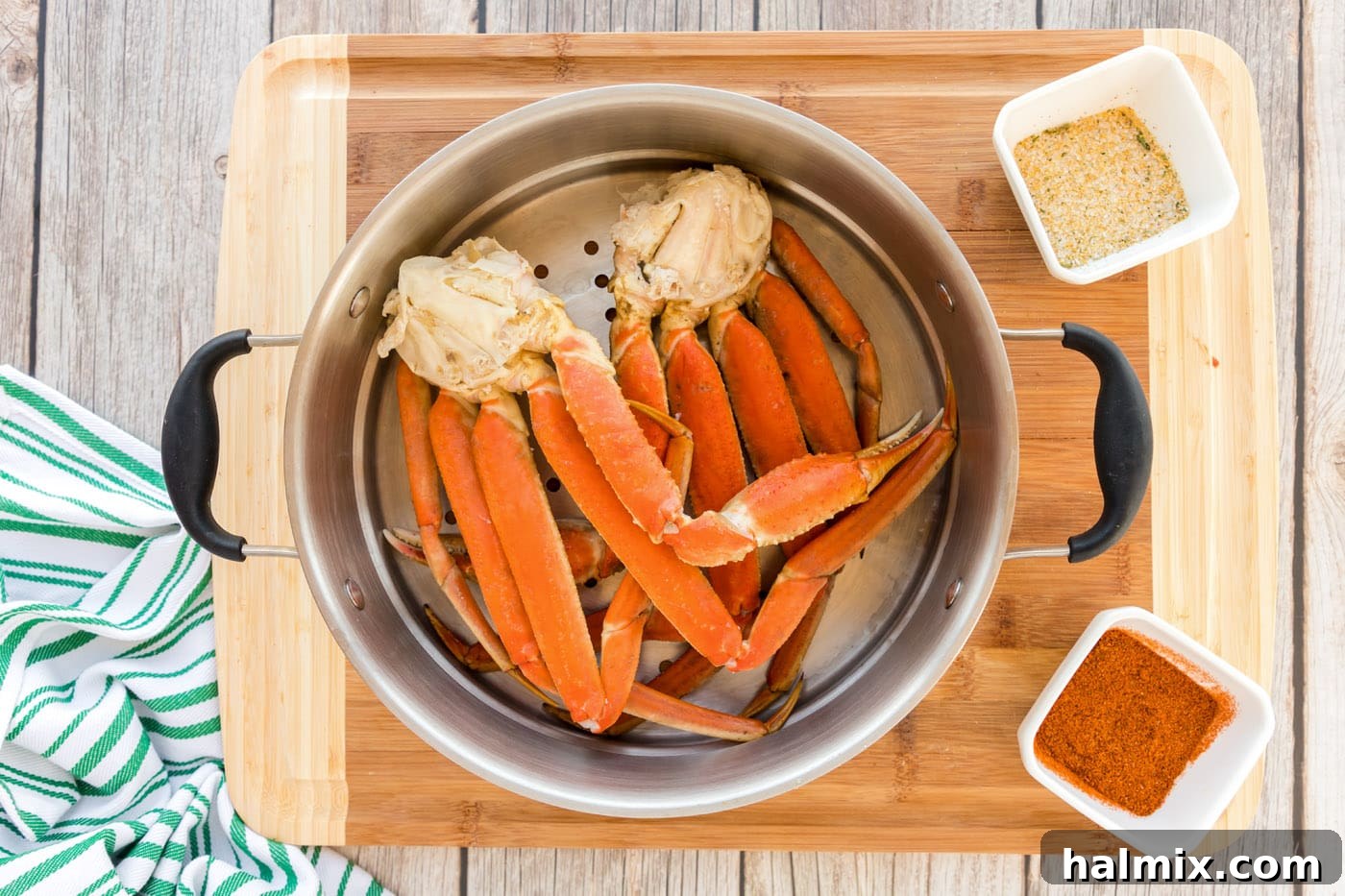 snow crab legs in steamer basket with water