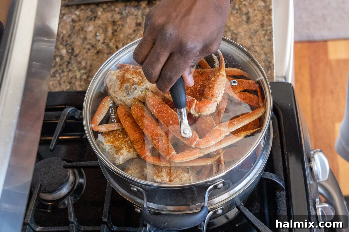 placing lid on steam pot with snow crab legs