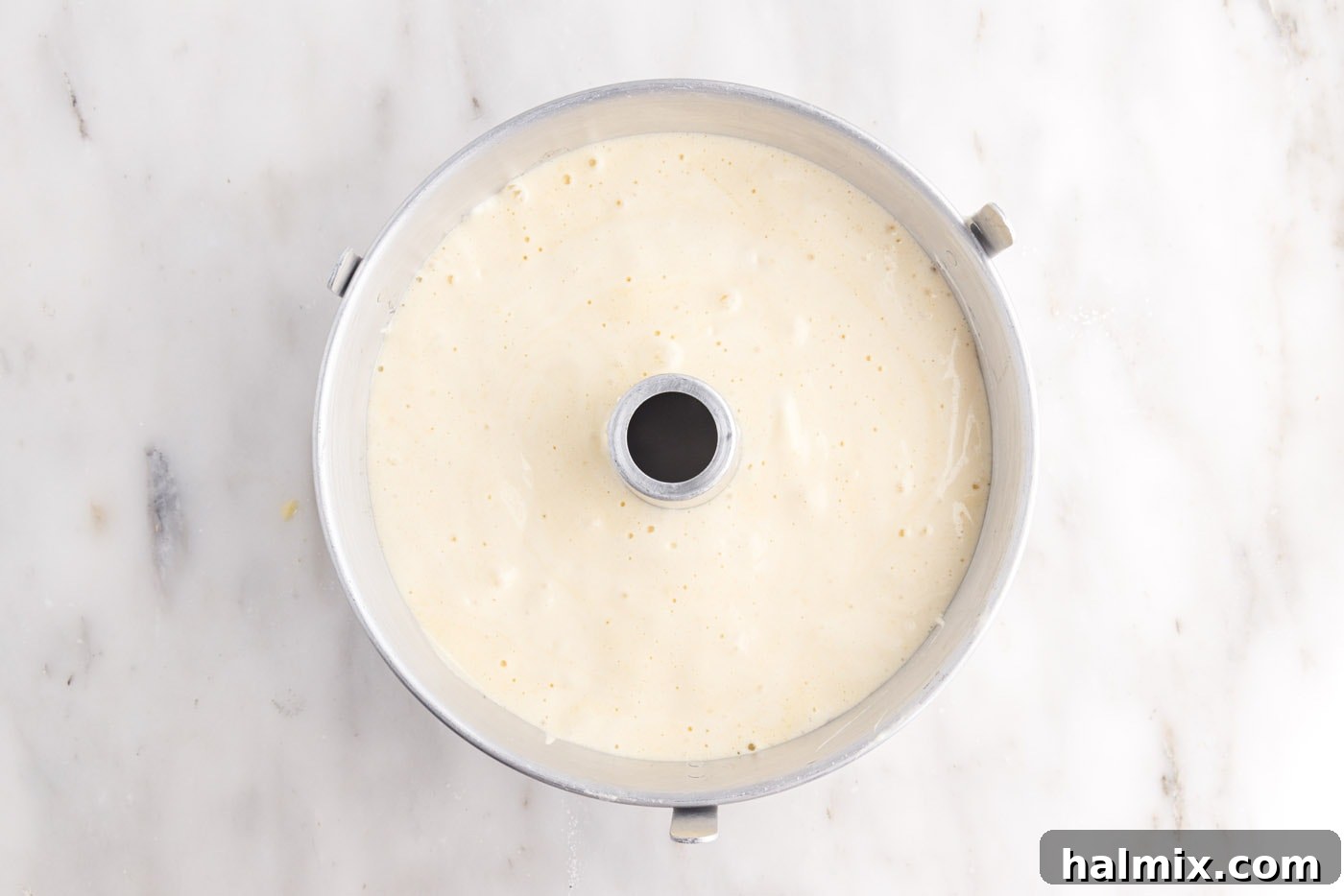 Chiffon cake batter perfectly poured into an ungreased tube pan