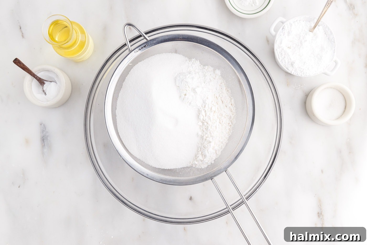 Sifting cake flour, sugar, baking powder, and salt into a bowl for Chiffon Cake batter