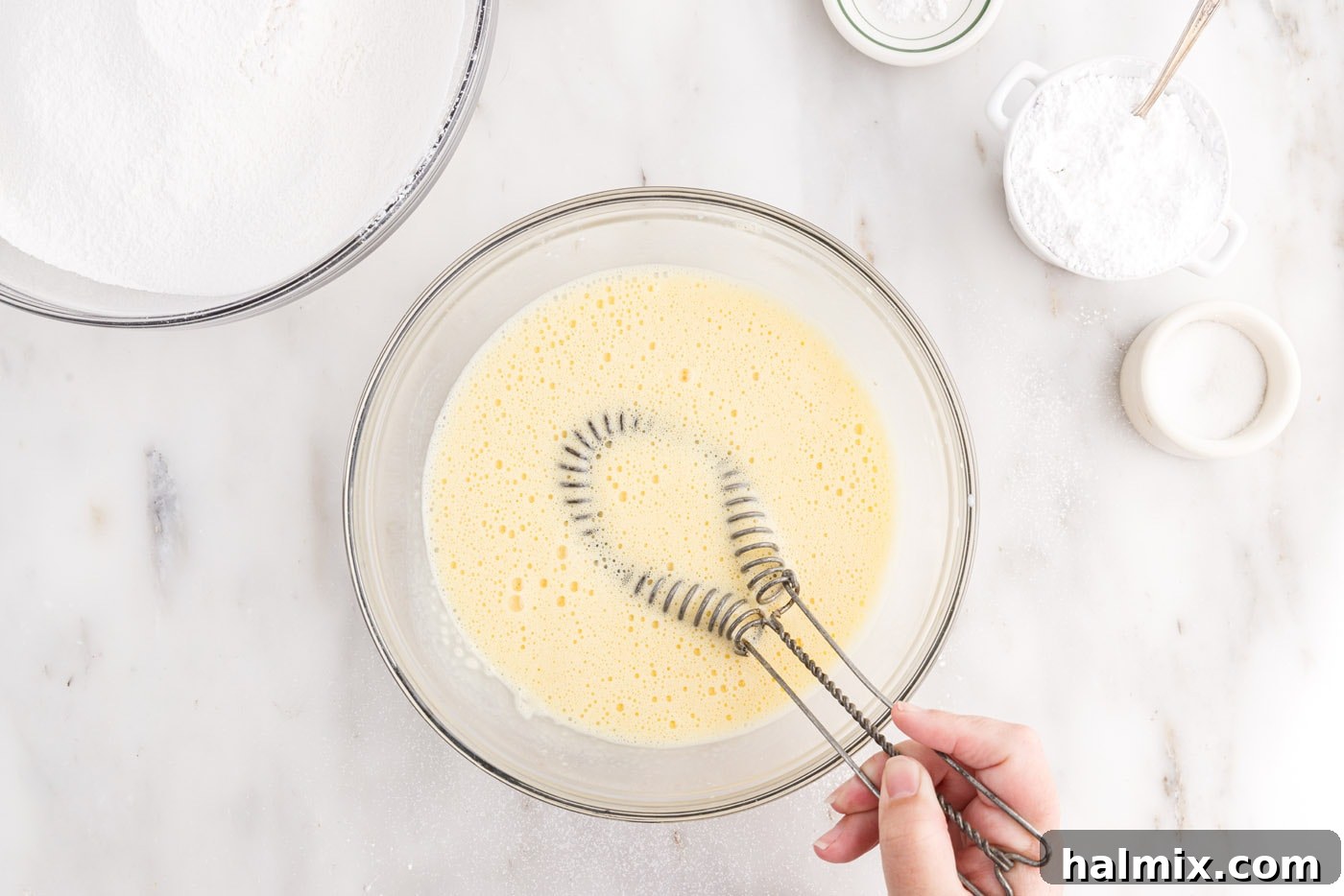 Egg yolk mixture perfectly whisked and foamy in a bowl
