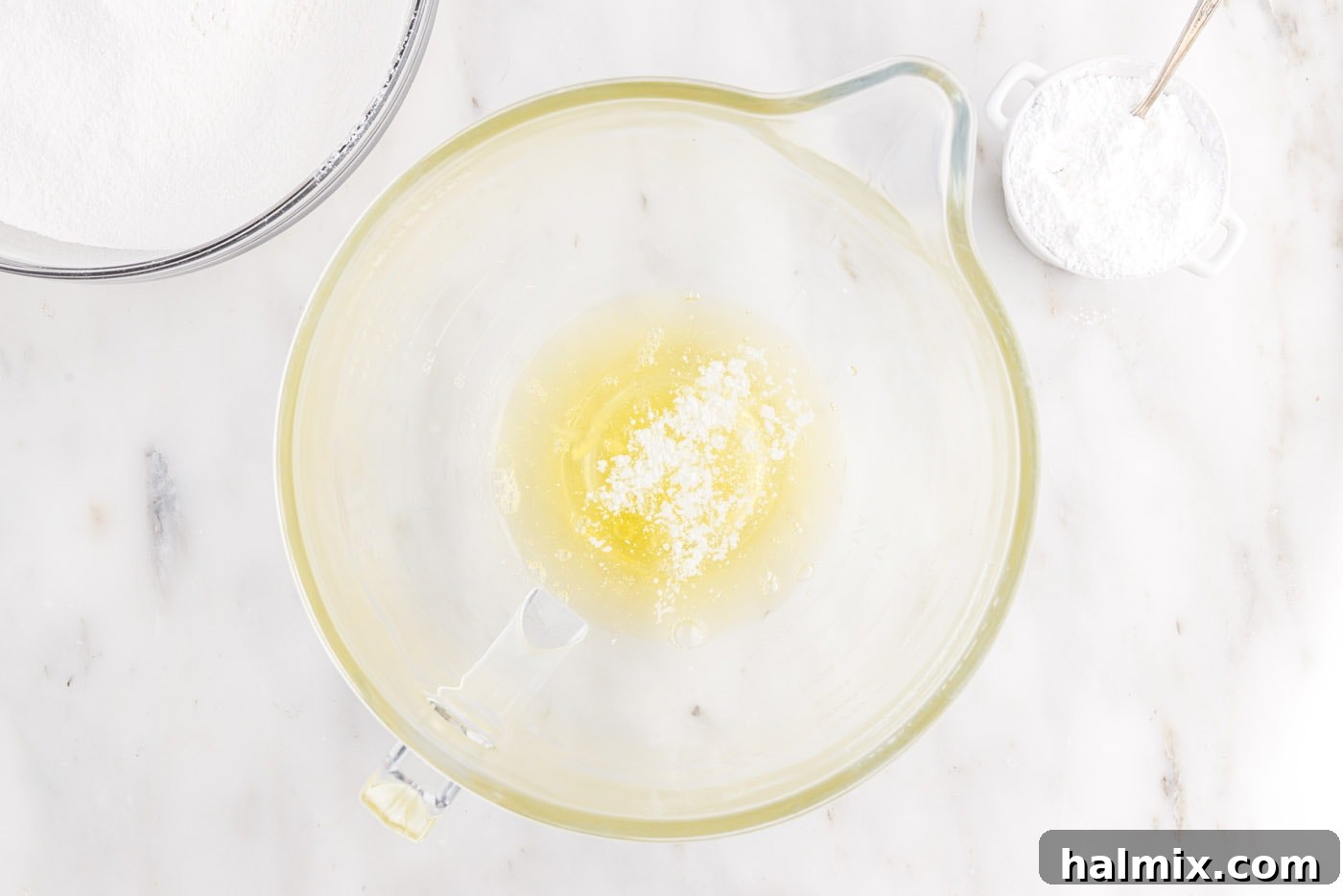 Egg whites and cream of tartar in a stand mixer bowl, ready to be whipped
