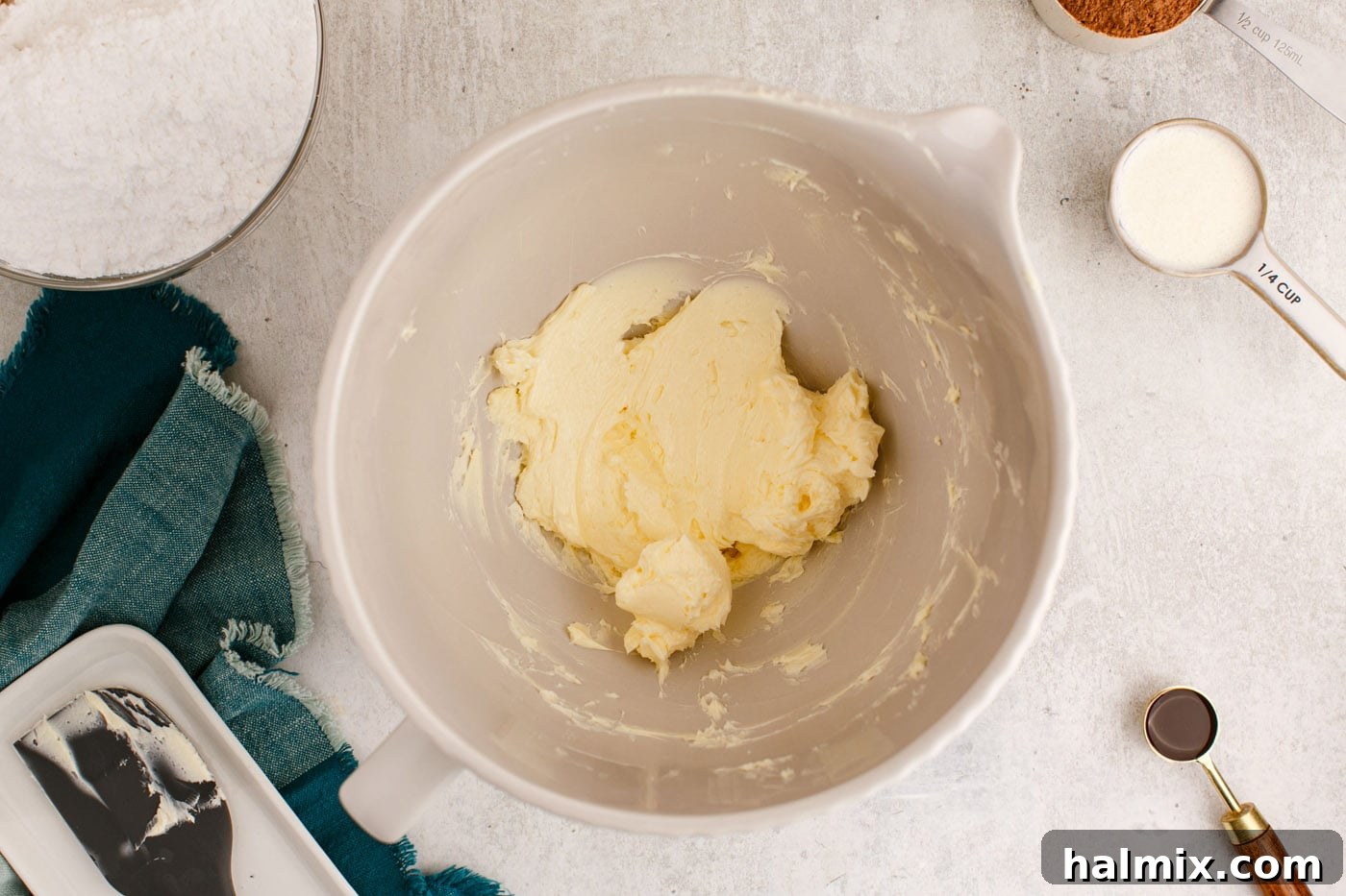 softened unsalted butter being vigorously whipped in a stand mixer bowl, turning pale and fluffy