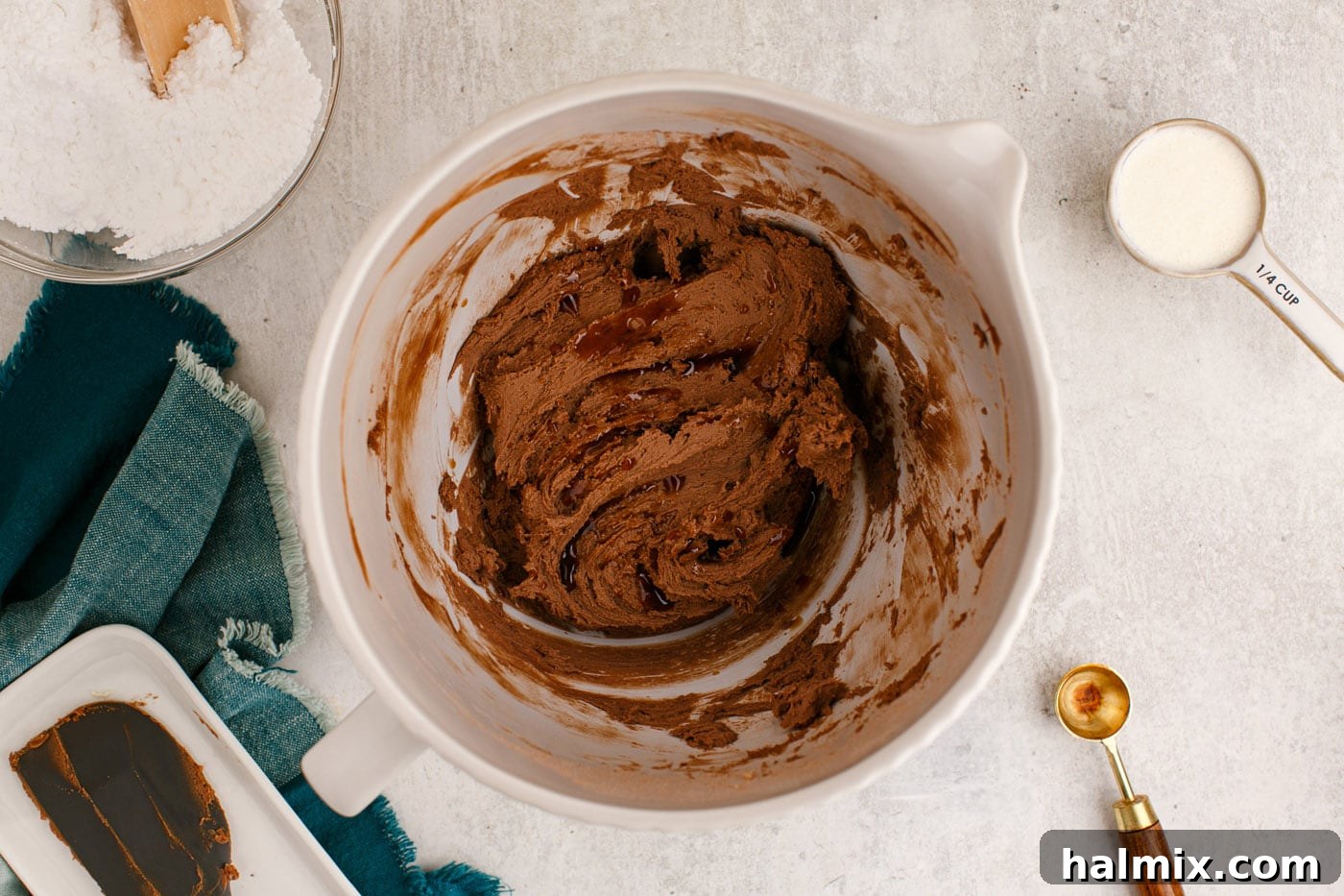 rich chocolate buttercream frosting in a mixer bowl with vanilla extract just added