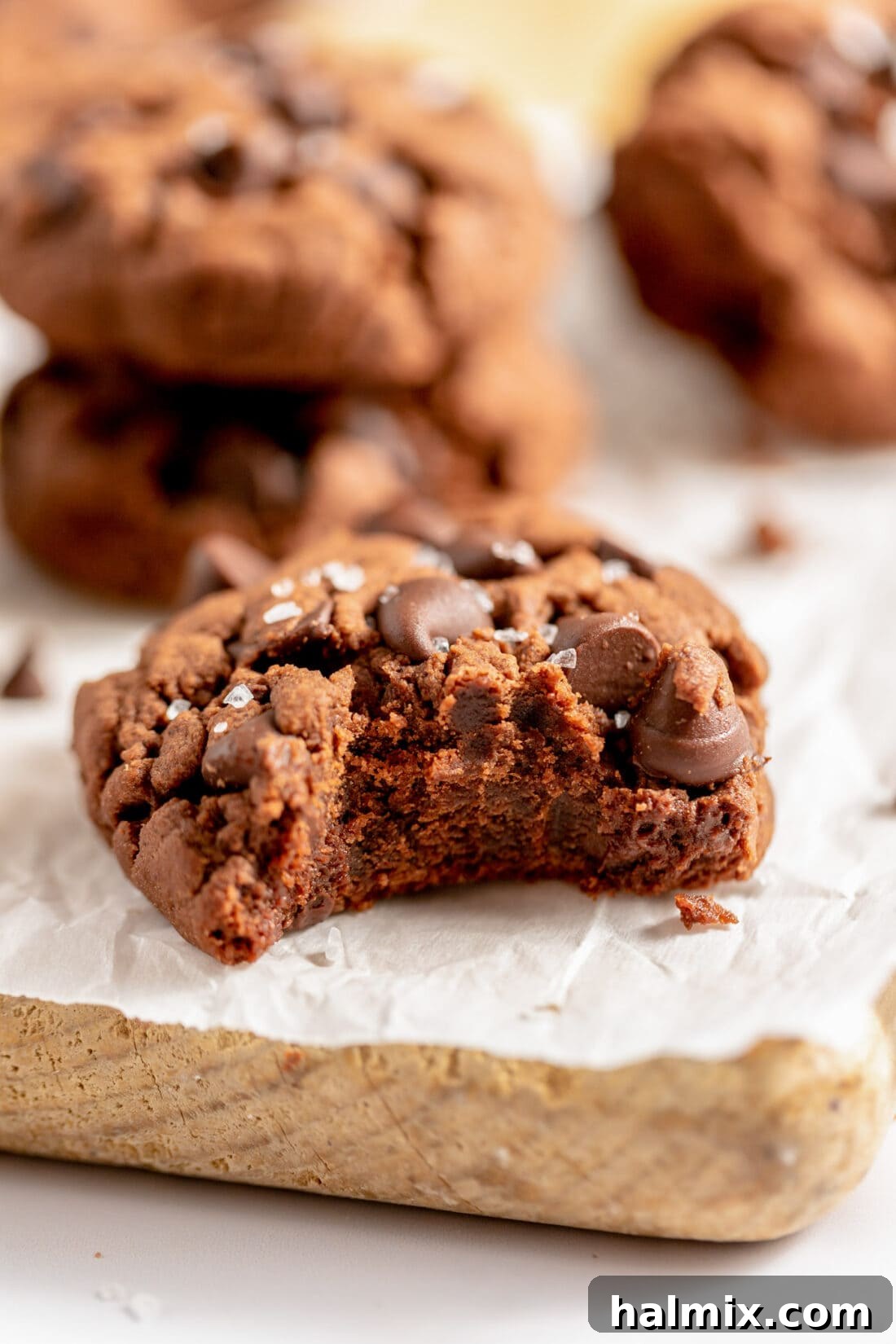 Luscious Chocolate Cake Mix Bites 2 A perfectly baked chocolate cake mix cookie with a bite taken out, revealing its soft, chewy interior and melty chocolate chips.