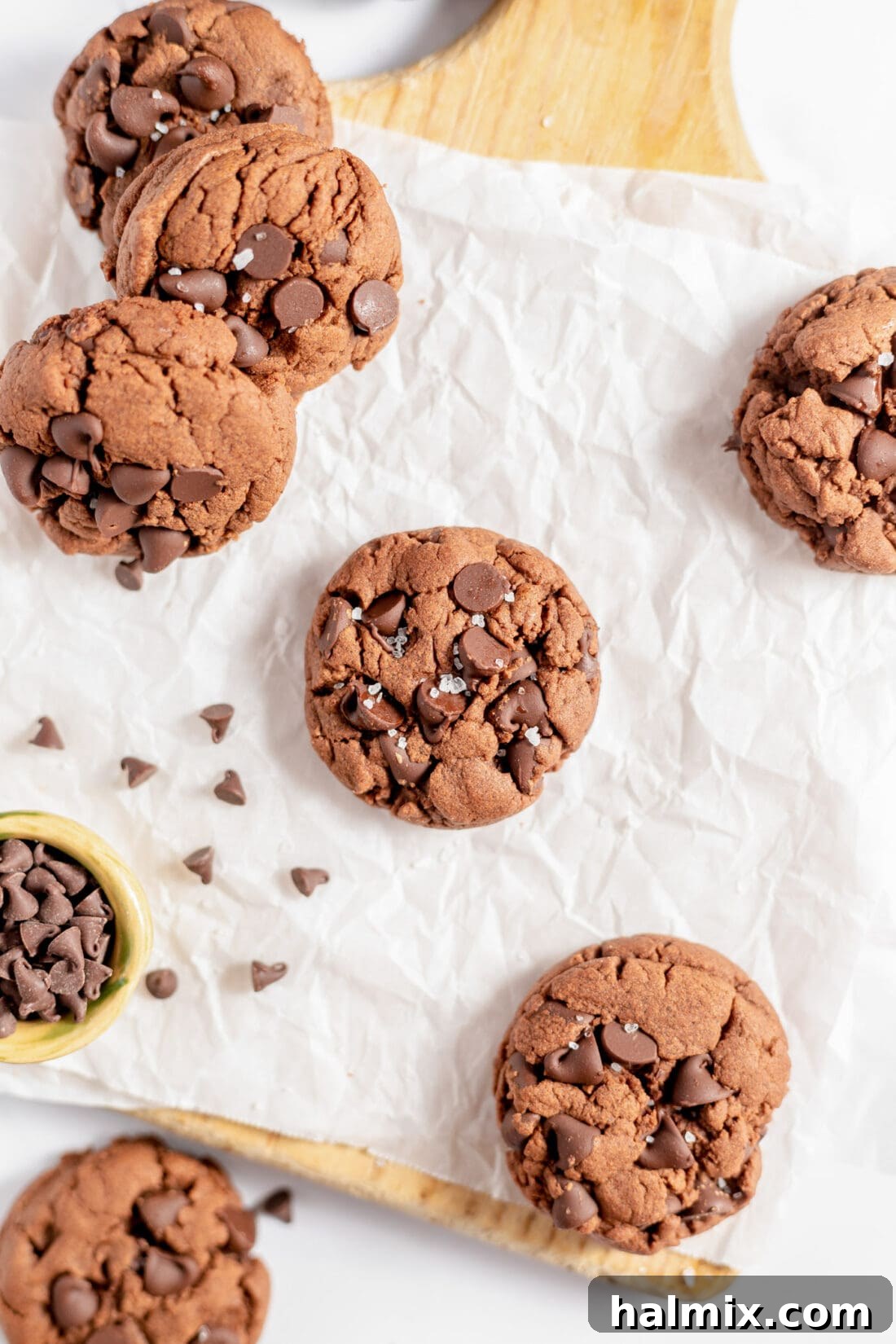 Luscious Chocolate Cake Mix Bites 12 Freshly baked chocolate cake mix cookies cooling on parchment paper on a baking sheet.