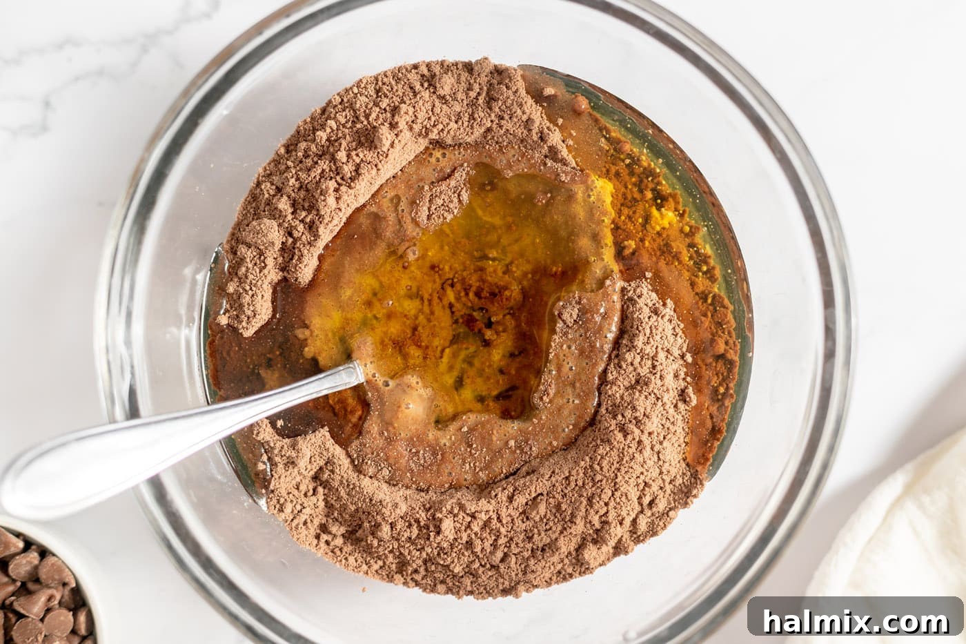 Luscious Chocolate Cake Mix Bites 7 Oil added to the beaten eggs and cake mix in a bowl.