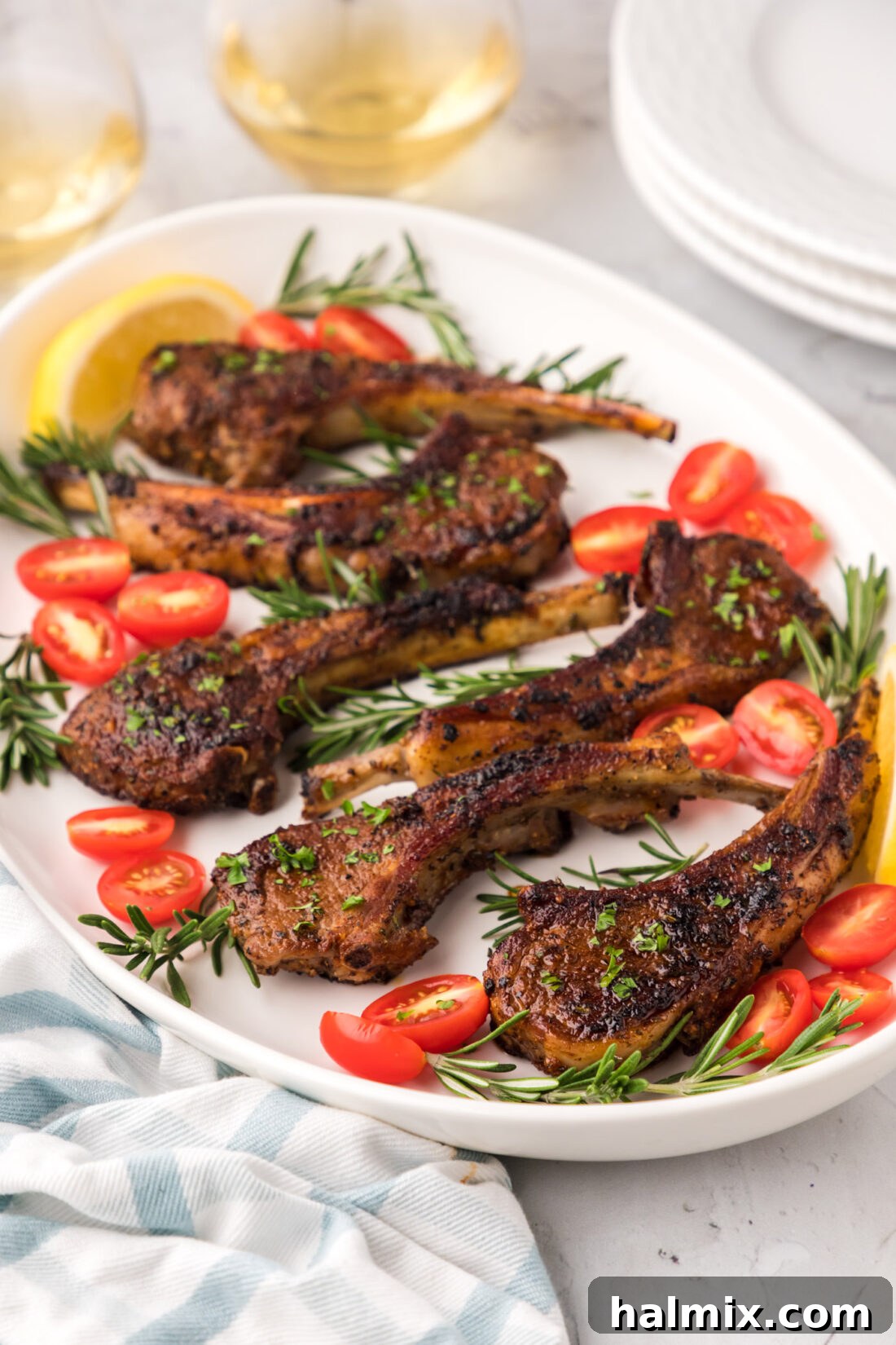 Platter of golden-brown baked lamb chops, garnished with fresh herbs
