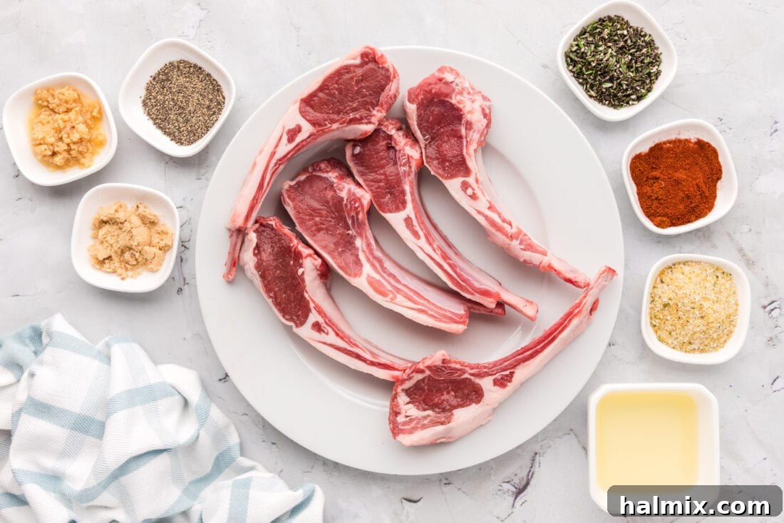 A collection of ingredients laid out, including lamb chops, spices, and olive oil