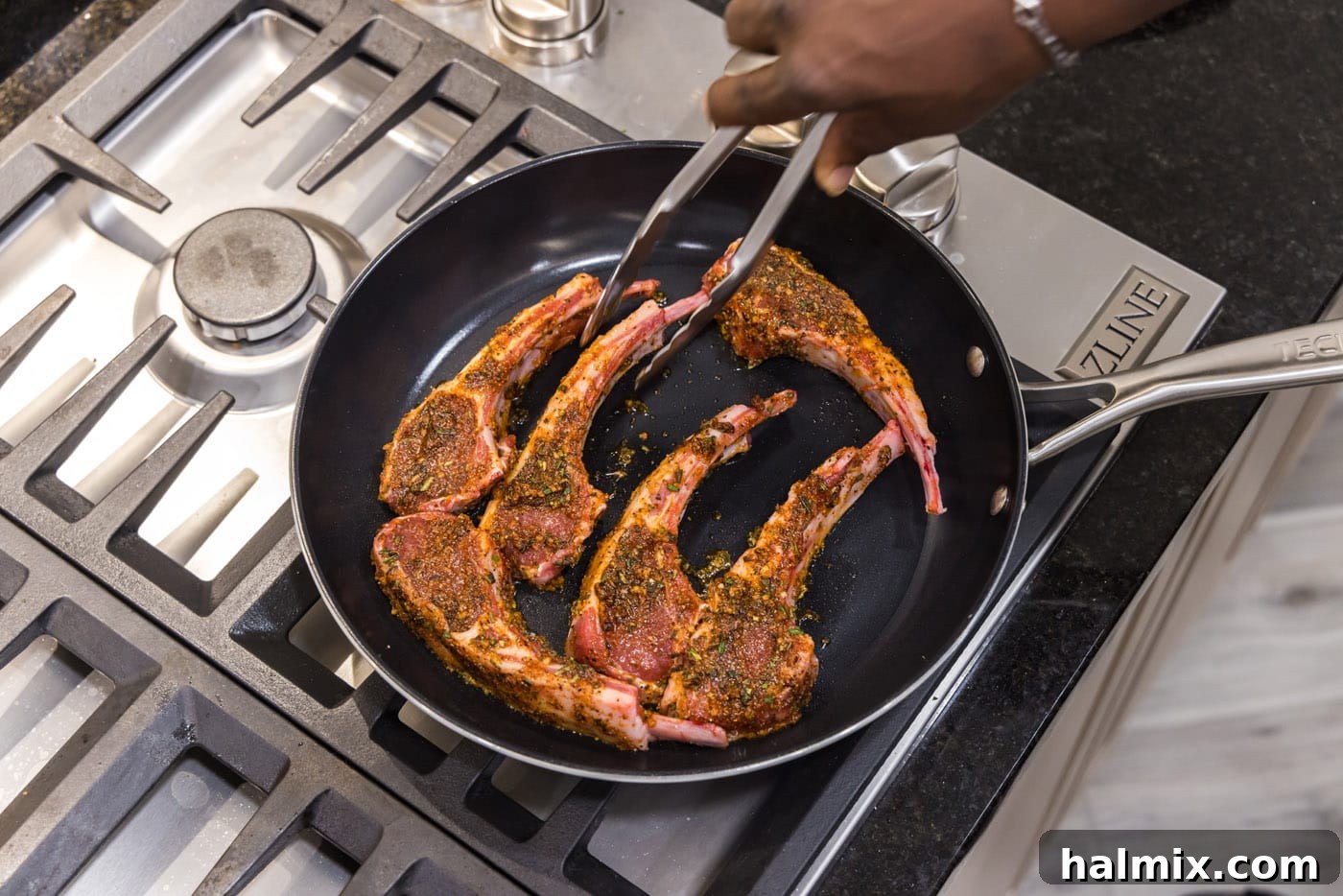 Lamb chop being placed into a hot skillet for searing