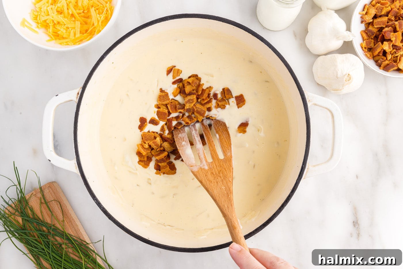 Hearty Loaded Baked Potato Soup 13 Stirring crispy crumbled bacon into the rich and creamy baked potato soup.