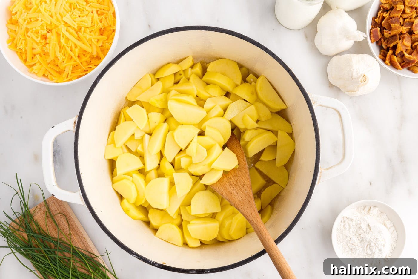 Hearty Loaded Baked Potato Soup 6 Diced potatoes cooking in a stockpot with sautéed onions and garlic.