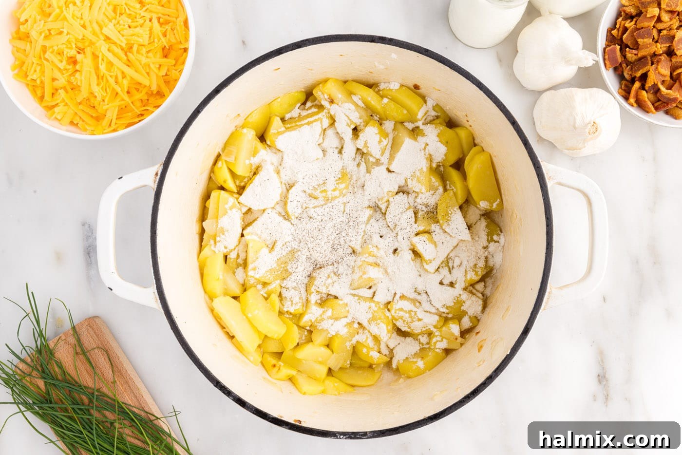Hearty Loaded Baked Potato Soup 7 Flour, salt, and pepper sprinkled over diced potatoes, onions, and garlic in a stockpot.