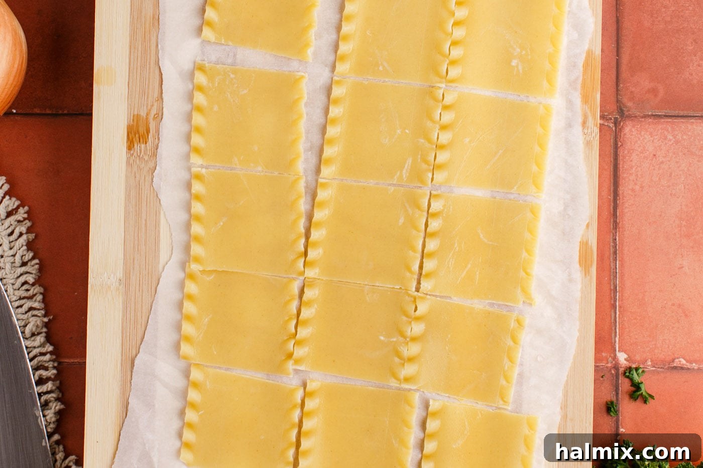 Cutting softened lasagna noodles into small squares on a cutting board for the soup