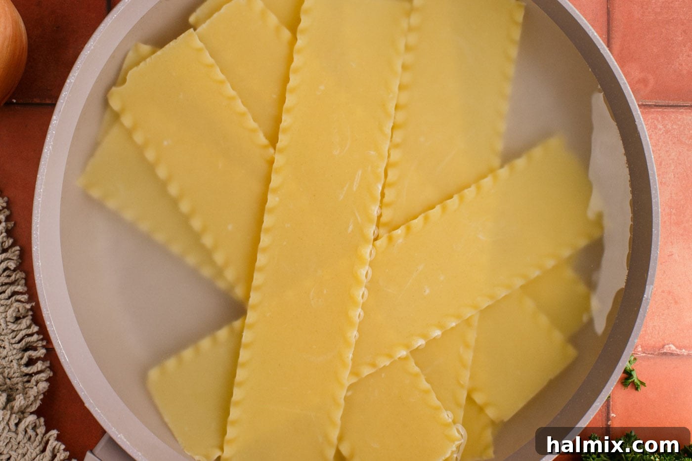 Softened lasagna noodles carefully removed from the water and ready for cutting