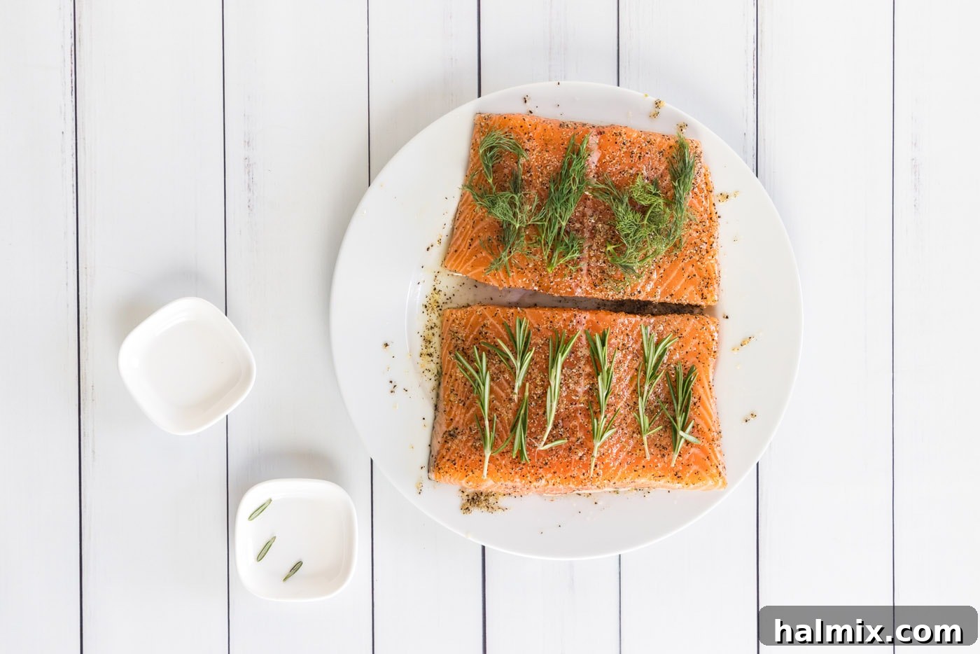 fresh herbs on top of salmon filets