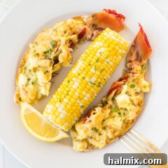Golden Lobster Indulgence 21 Lobster Thermidor on a plate with corn on the cob