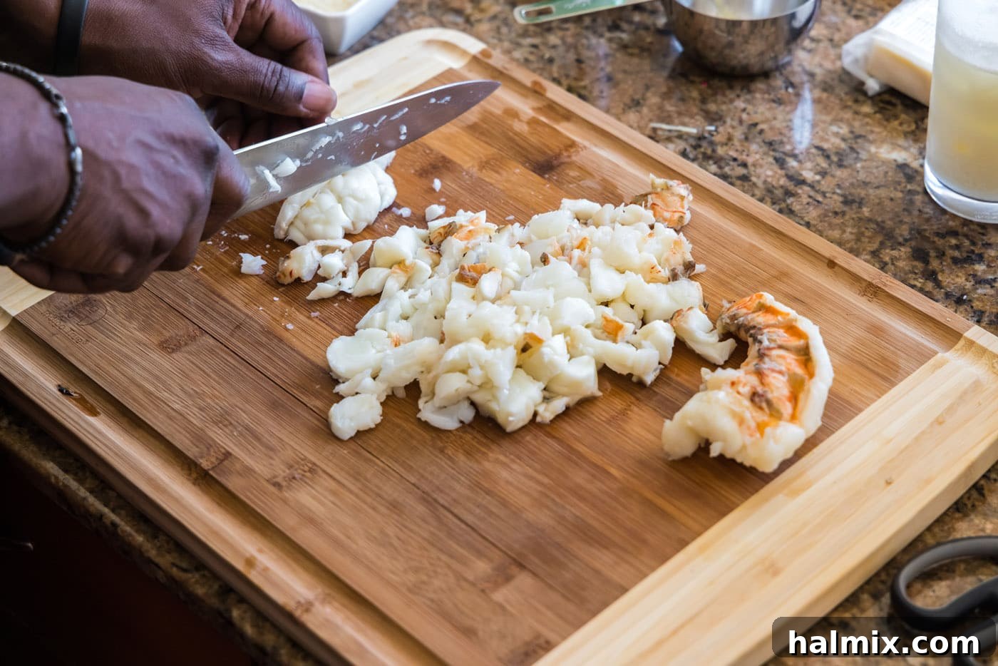 Golden Lobster Indulgence 8 chopping cooked lobster meat with a knife