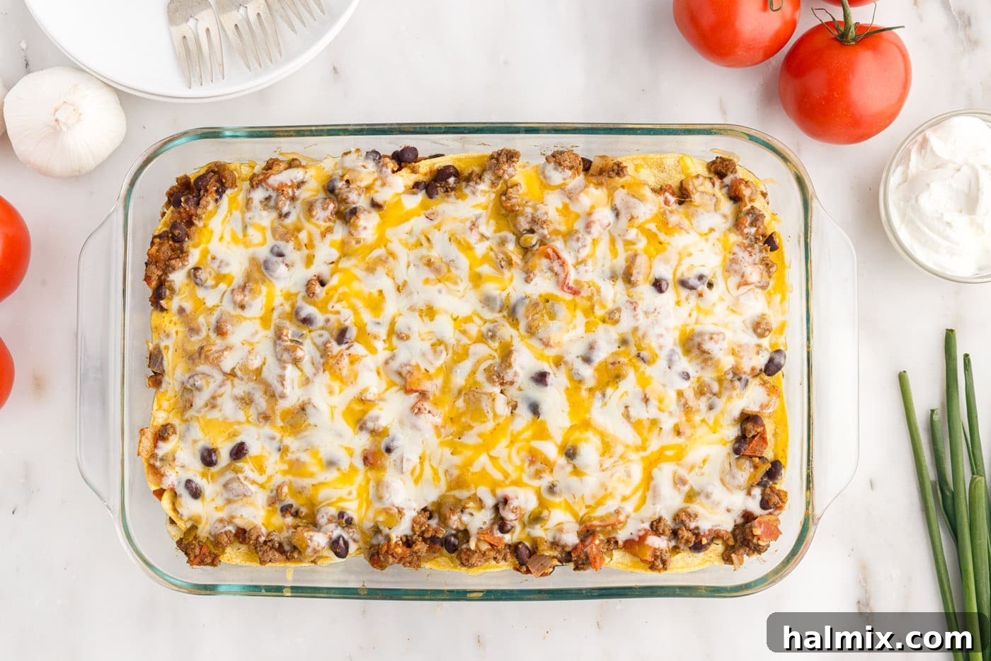 The fully baked Mexican lasagna casserole, bubbly and golden, fresh from the oven