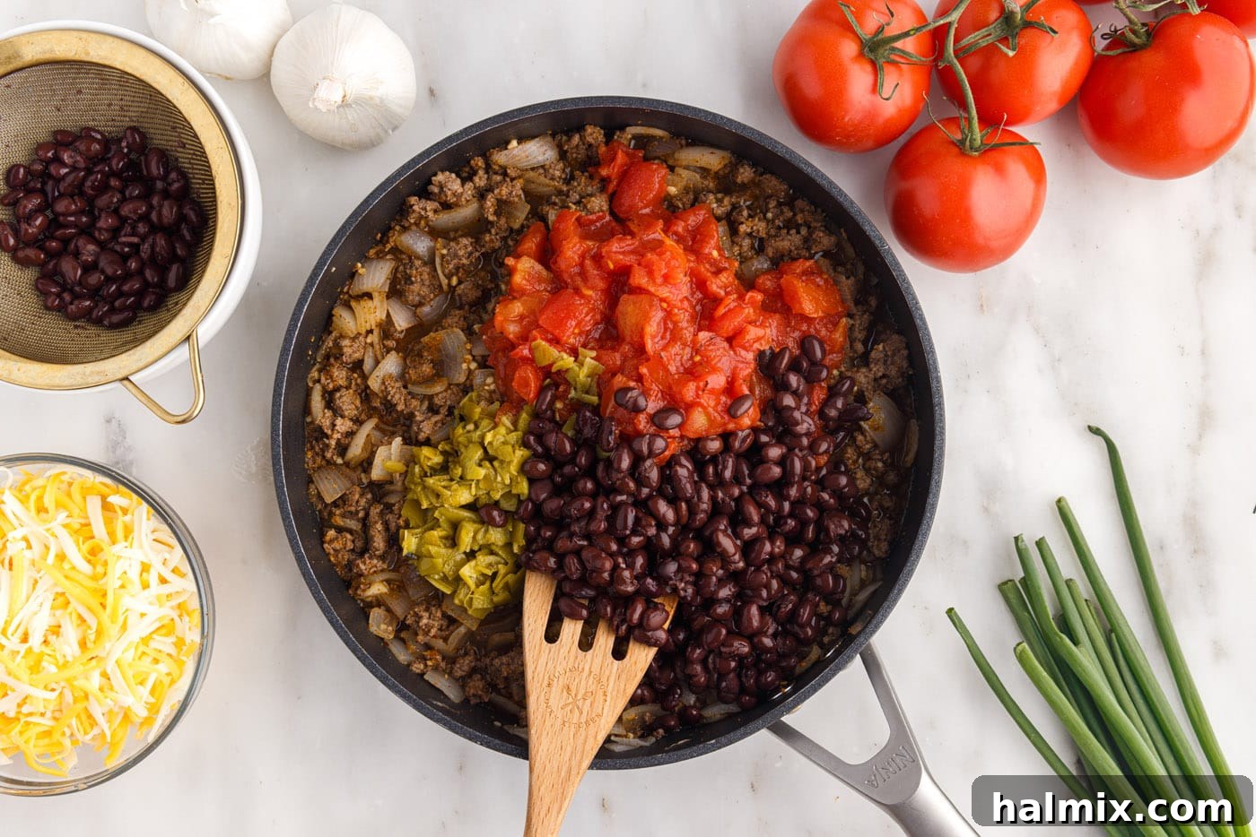 Black beans, green chiles, and fire-roasted tomatoes added to the ground beef mixture, adding color and texture