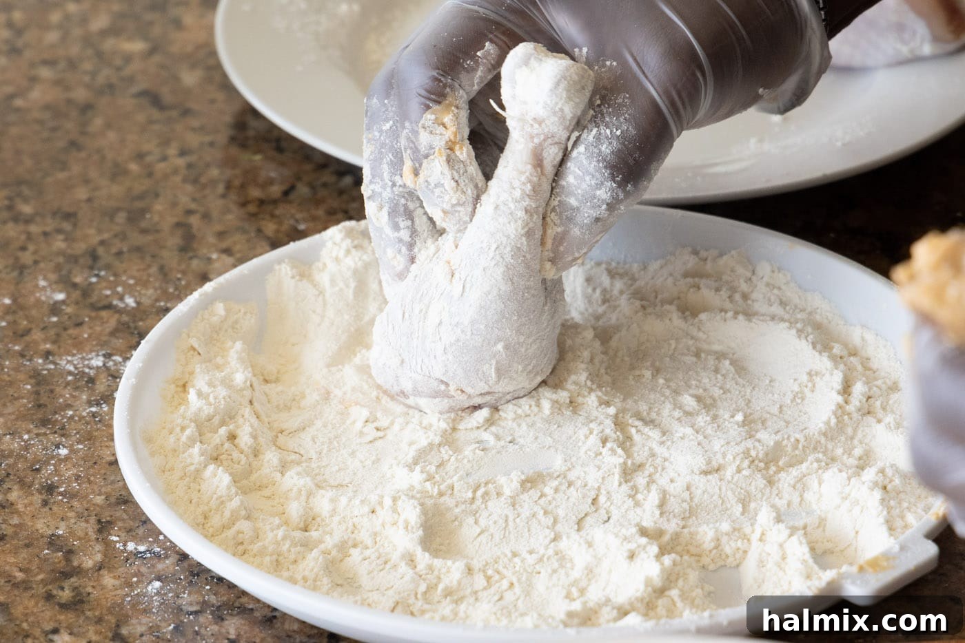 coating chicken legs in flour