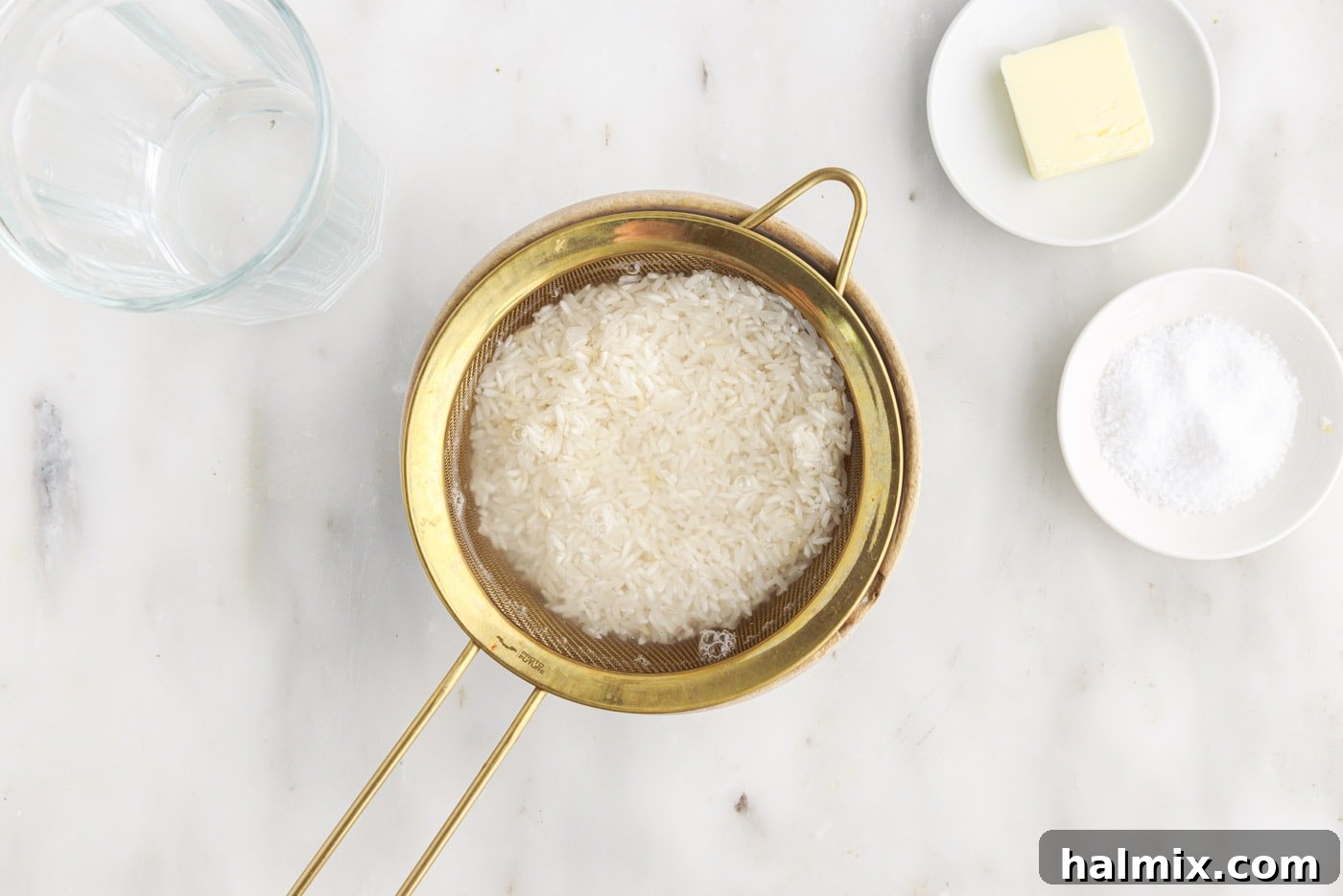 Close-up of rinsing rice with water in a sieve