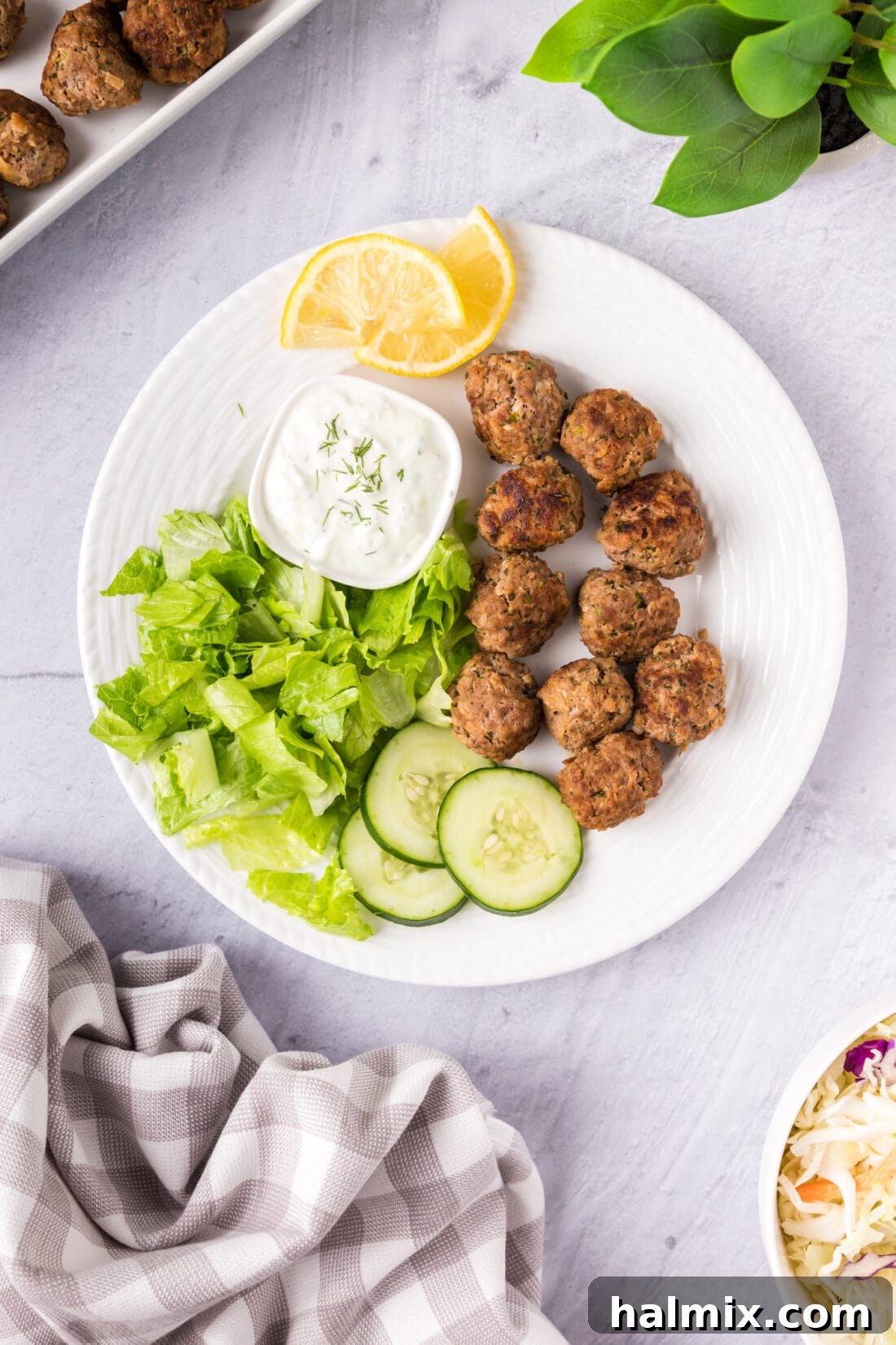 A beautifully presented platter of perfectly cooked lamb meatballs, garnished and ready to be served.