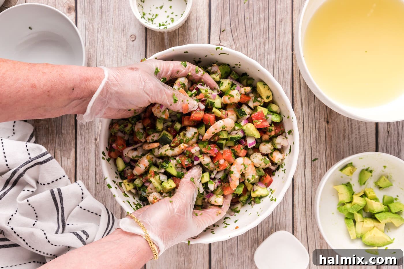 Zesty Shrimp Ceviche 14 hands mixing shrimp ceviche in a bowl