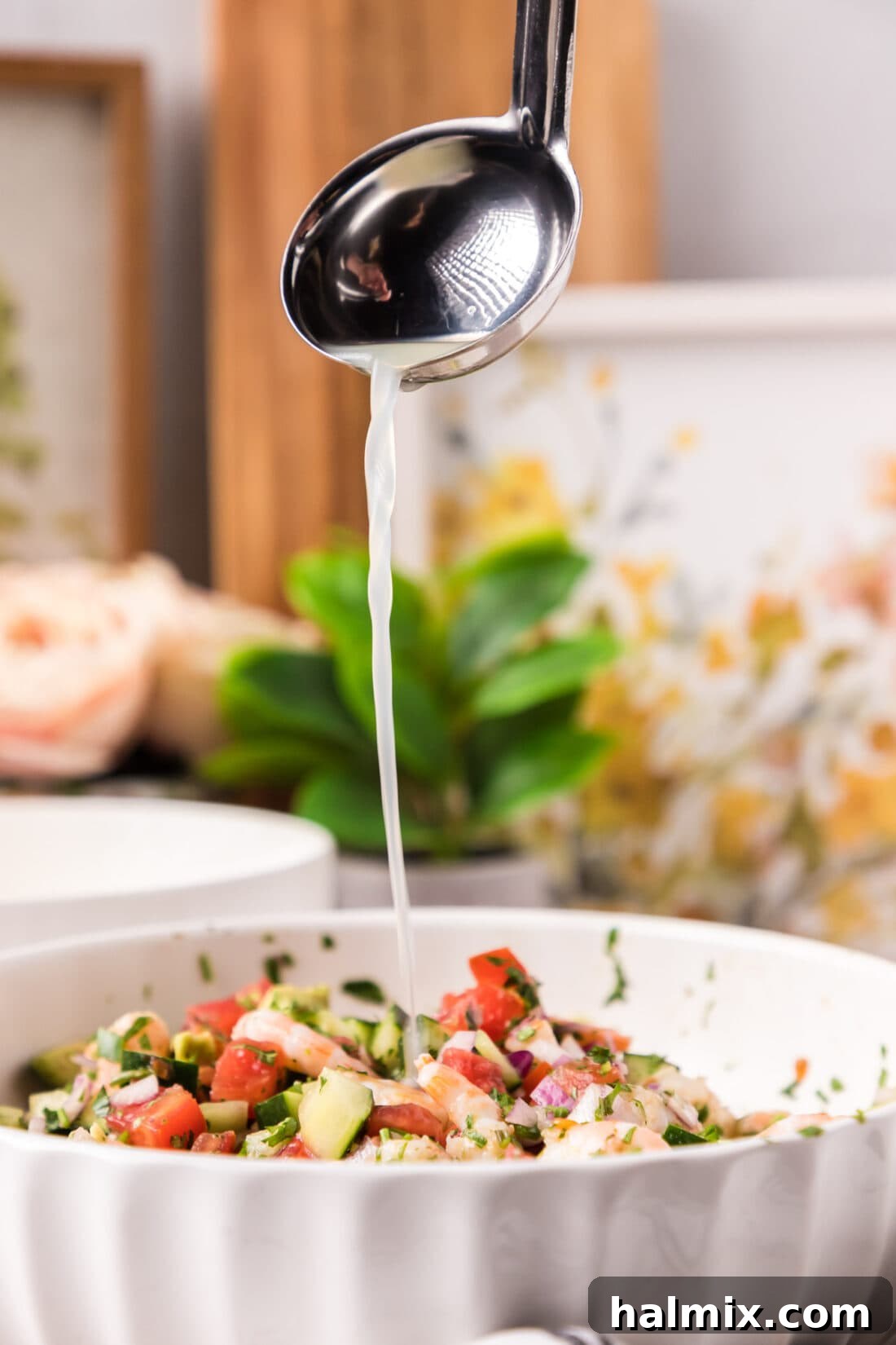 Zesty Shrimp Ceviche 15 Ladle of fruit juices being poured into a bowl of Shrimp Ceviche