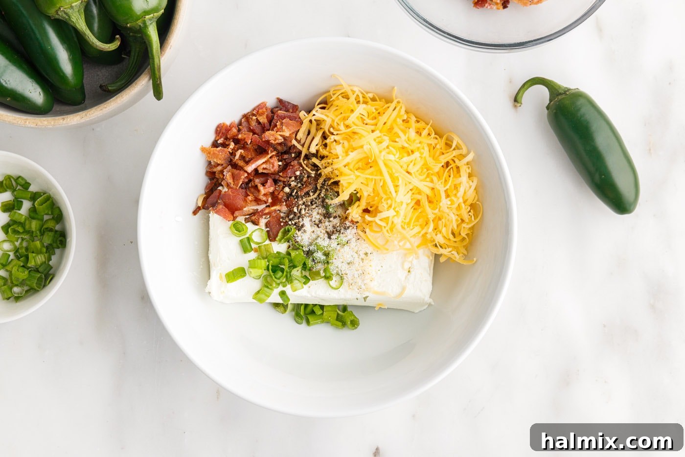crumbled bacon, cream cheese, cheddar cheese, green onion, and seasonings in a bowl