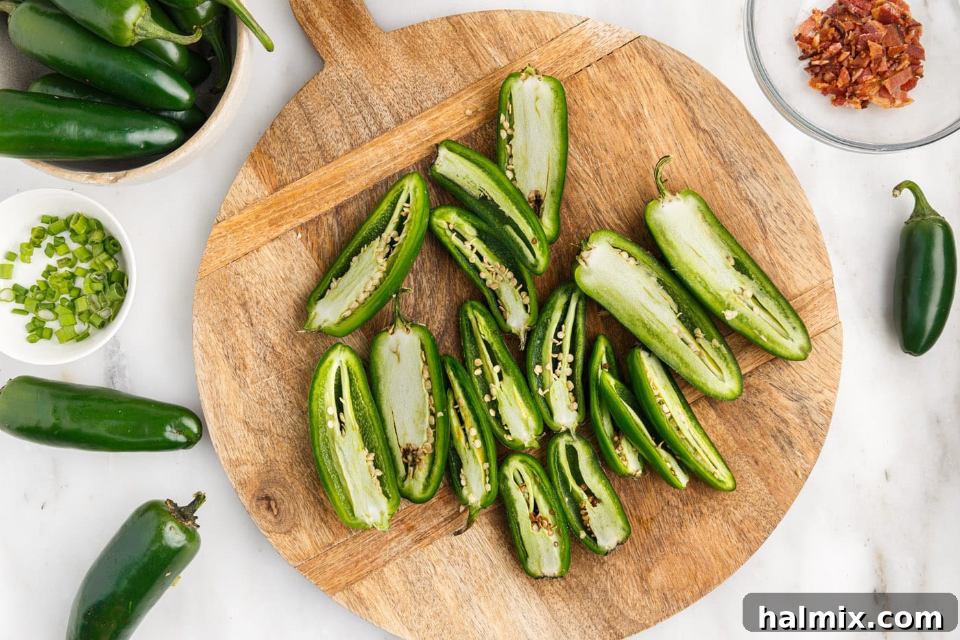 sliced jalapeno peppers on a cutting board